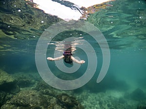 Underwater portrait of a woman snorkeling in tropical sea