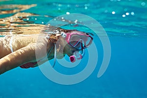 Underwater portrait of young lady snorkeling in mask