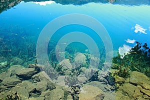 Underwater Reef Scene in Lugu lake , Inverted reflection in clear water