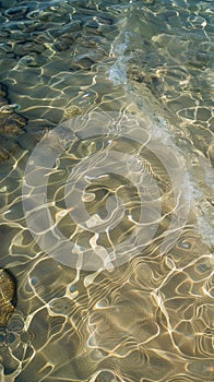 Underwater sand patterns with light reflections