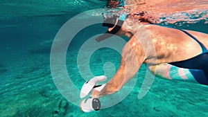 Underwater scooter. Woman swims using modern innovative diving gadget.