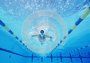 Underwater shot of male swimmer swimming in pool