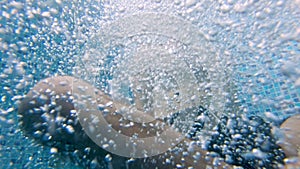 Underwater shot of man jumping to a pool