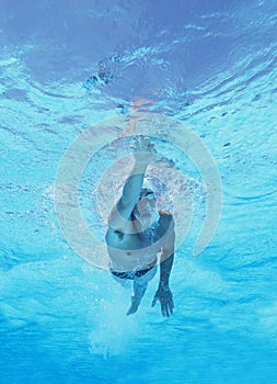 Underwater shot of professional male athlete swimming in pool