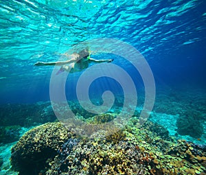 Underwater shot of a woman snorkeling in the sun