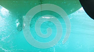 Underwater shots of a Man with his surfboard