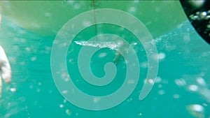 Underwater shots of a Man with his surfboard