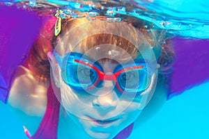 Underwater swimming girl goggles blue water