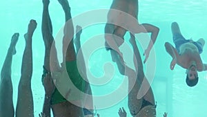 Underwater view of friends swimming together