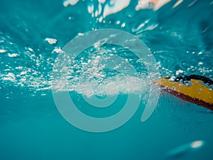 Underwater view of a moving inflatable ring that floating in the water