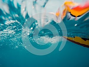 Underwater view of a moving inflatable ring that floating in the water