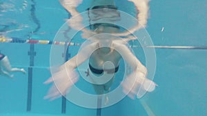 Underwater view of pregnant swimming in the pool.