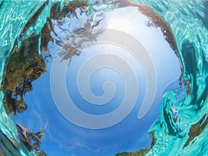 Underwater view of the sky. Outdoor swimming pool in tropical. Blue defocus background