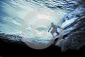 Underwater view of surfer riding wave