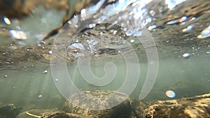 Underwater view under surface of flowing water current stream