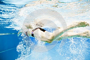 Underwater View Of A Young Couple Swimming In The Pool