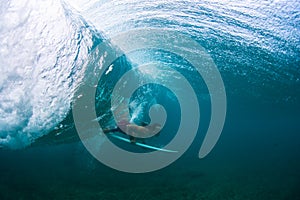 Underwater view of the young male surfer