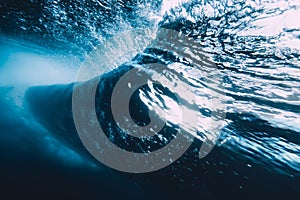 Underwater wave with sun light. Barrel wave crashing in ocean