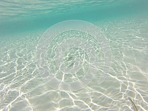 Underwater white sand with reflection