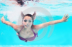 Underwater woman portrait in swimming pool