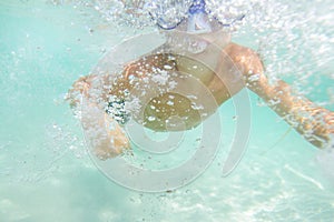 Underwater young boy diving