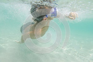 Underwater young boy diving
