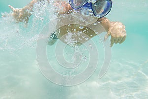 Underwater young boy diving