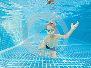 Underwater Young Boy Fun in the Swimming Pool with Goggles. Summer Vacation Fun