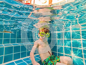 Underwater Young Boy Fun in the Swimming Pool with Goggles. Summer Vacation Fun