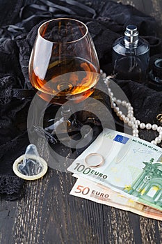 Underwear, cognac and money to symbolize the cost of sex
