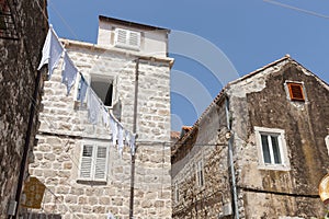 Underwear washing hang out to dry between old stone European buildings