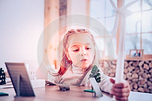 Undistracted schooler doing windmill and solar system for Ecology