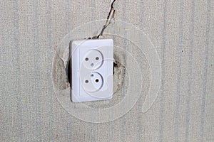 Undone AC power socket in wall. Repairs in the apartment