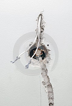 Undone AC power socket in wall.