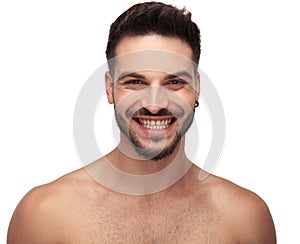 Undressed unshaved guy smiling and showing his teeth