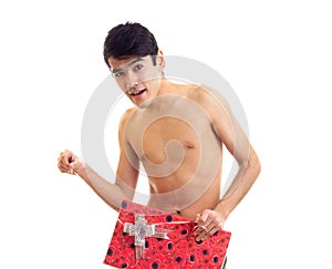 Undressed young man holding present