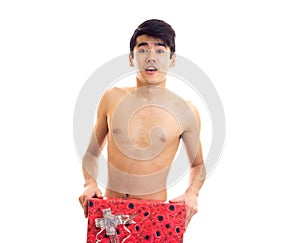 Undressed young man holding present