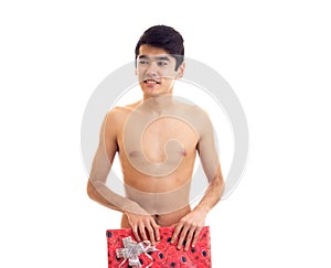 Undressed young man holding present