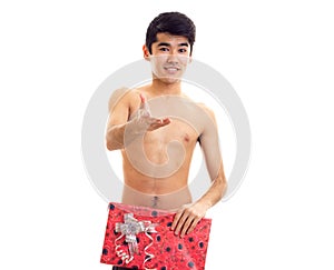 Undressed young man holding present