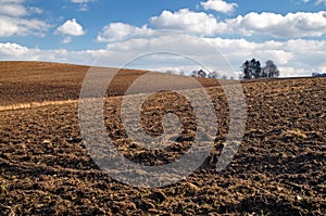 Undulating plowed field in early spring