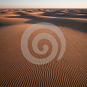 Undulating sand dunes under a clear