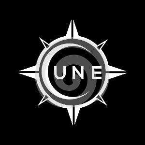 UNE abstract technology logo design on Black background. UNE creative initials letter logo concept photo