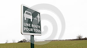 Une route pour tous french text means translate : road sharing cars and bikes photo