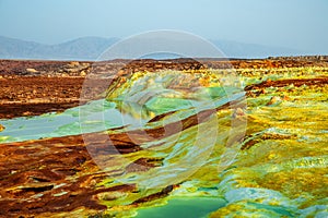 Unearthy landscape with toxic lakes and sulphur minerals, Danakil Depression desert, Afar region, Ethiopia photo
