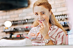 Uneasy mature woman opting nail polish