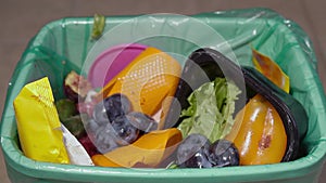 Uneaten rotten fruits are thrown in the trash. Food Loss and Food Waste. Reducing Wasted Food At Home