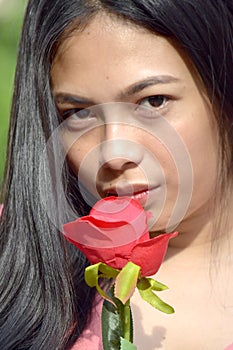Unemotional Adult Female With A Rose