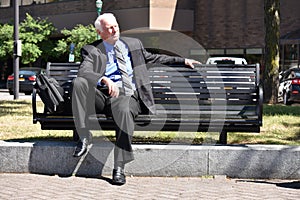 Unemotional Adult Senior Person Sitting On Bench