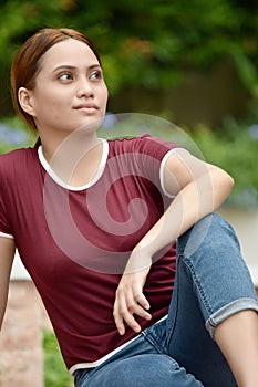 An Unemotional Attractive Redhead Adult Sitting