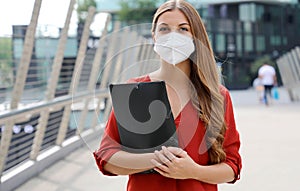 Unemployed serious woman with KN95 FFP2 protective mask looking worried at camera